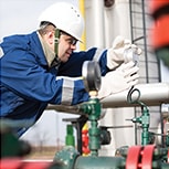 Mobil engineer inspecting an industrial machine