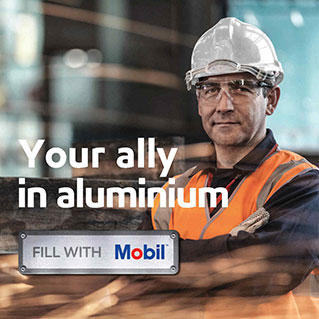 Mobil worker in a factory with his arms crossed, with the supporting copy – your ally in aluminium